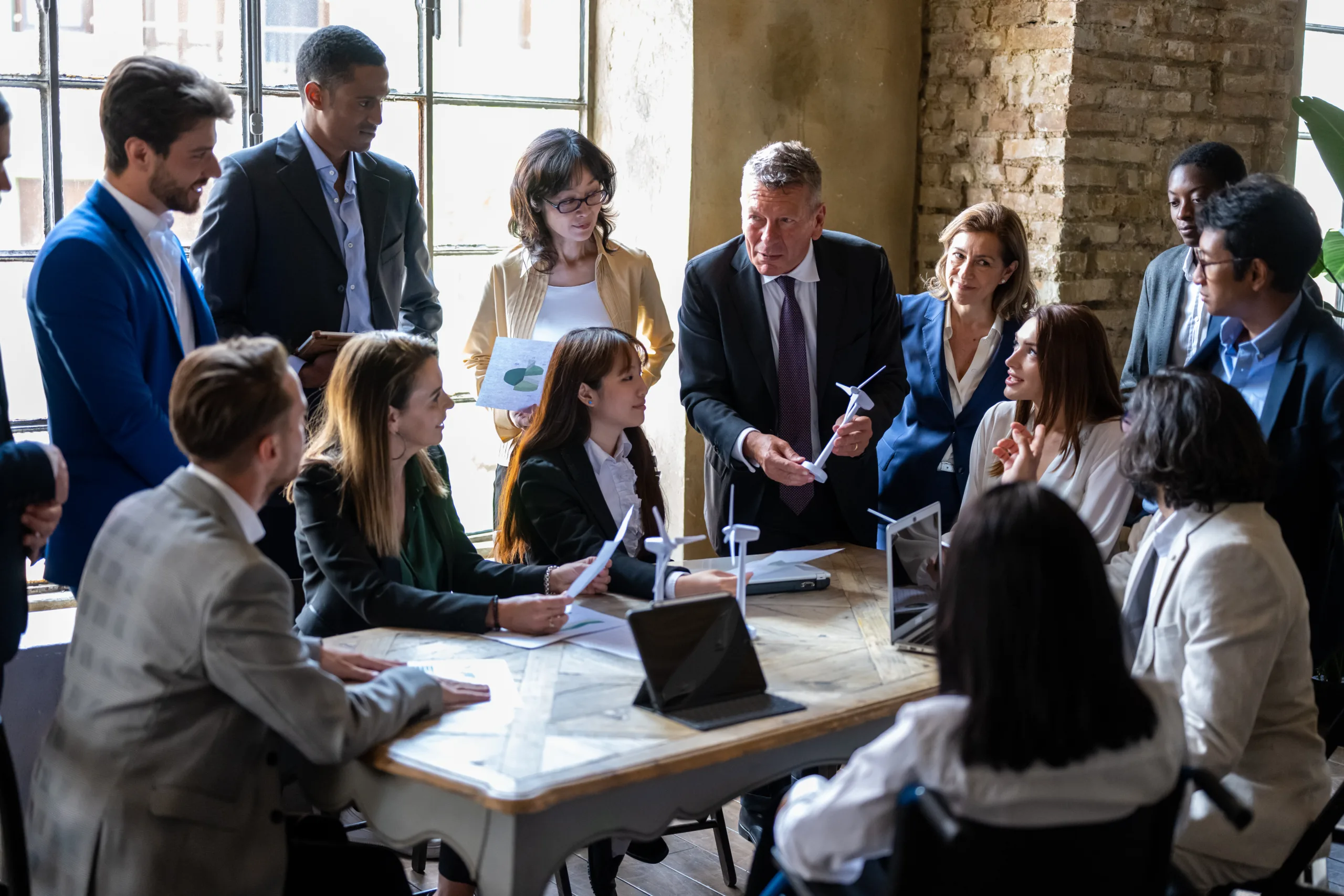 Meeting of entrepreneurs and engineers at the discussion table on energy projects from renewable and sustainable sources for the environment, international teamwork briefing